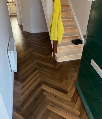 Dark herringbone LVT hallway fitted by CTP Carpentry